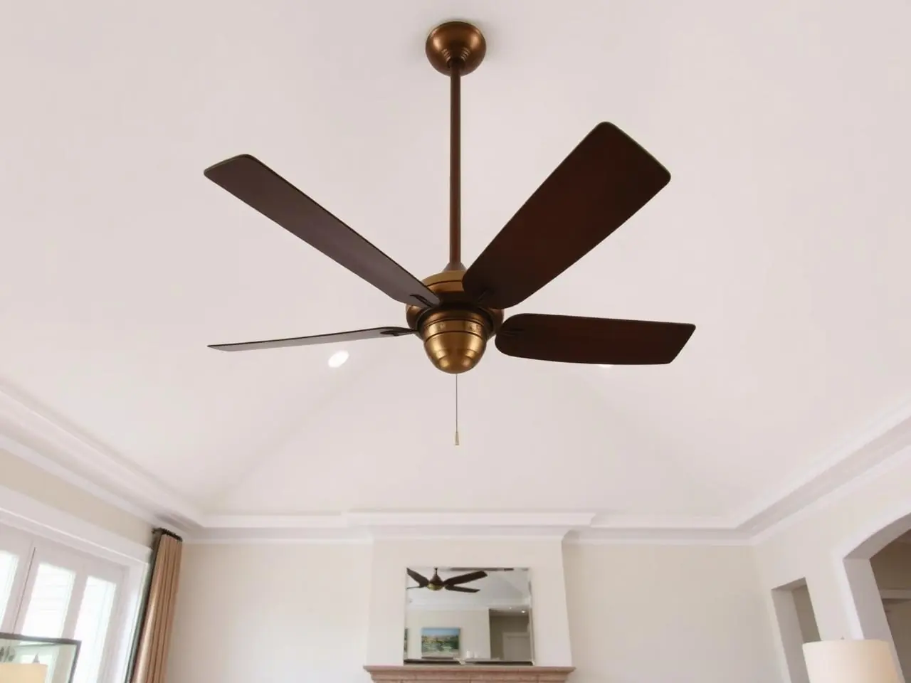 Ceiling fan installation in Boca Raton vaulted great room with large bronze fan suspended from sloped white ceiling